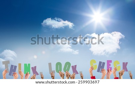 Hands holding up think look check against bright blue sky with clouds
