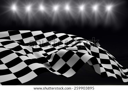 Checkered flag against football pitch at night with lights