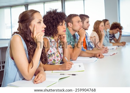 Fashion students being attentive in class at the college