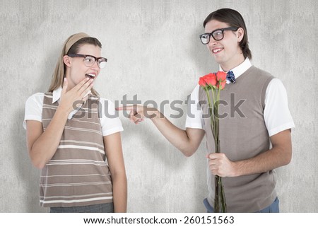 Geeky hipster offering red roses to his girlfriend against white background