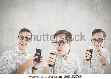 Nerd with tape recorder against white and grey background