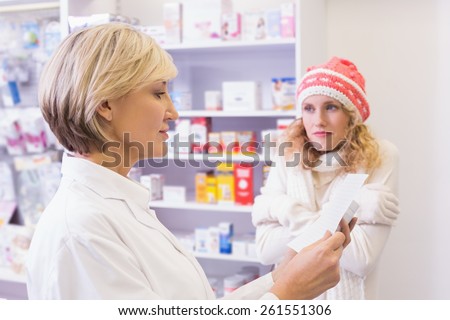Pharmacist explaining the drug to patient at pharmacy