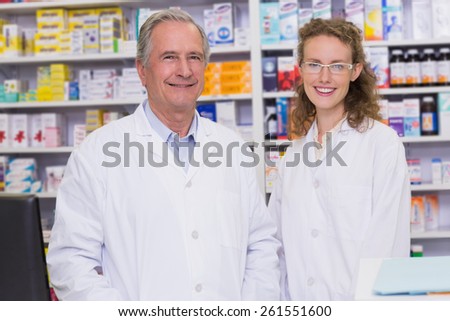 Pharmacists looking at the camera in the pharmacy