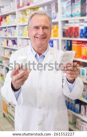 Senior holding medicine box and prescription at hospital pharmacy