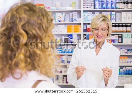 Pharmacist looking at prescription at pharmacy