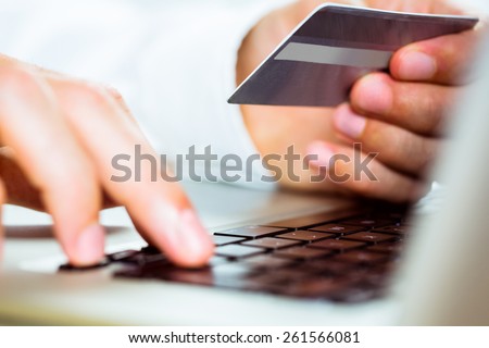 Man using laptop for online shopping in close up