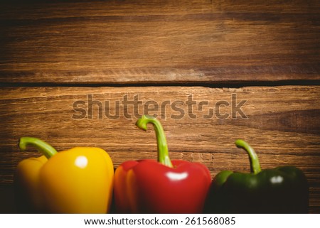 Three peppers on chopping board with copy space
