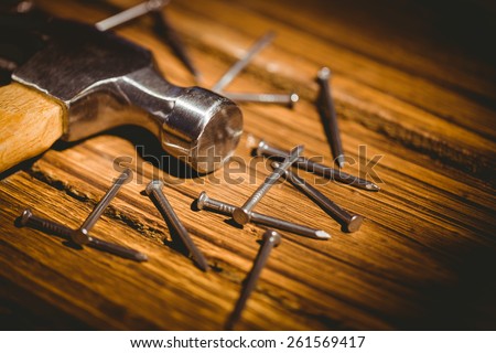 Hammer and nails laid out on table shot in studio