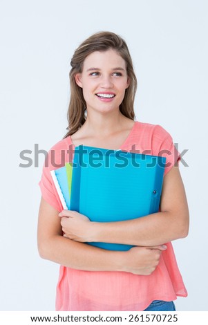 Smiling hipster holding notebook on white background