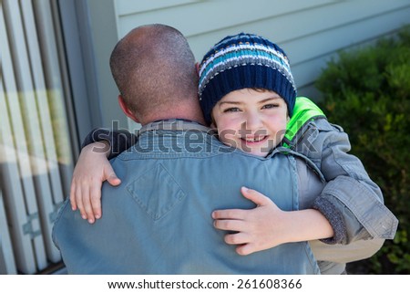 Father and son hugging in the countryside