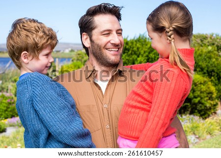 Happy family smiling at camera in the countryside