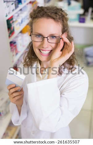 Pharmacist holding medicine jar at the hospital pharmacy