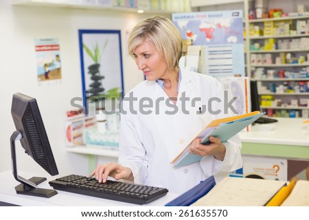 Pharmacist using the computer at the pharmacy