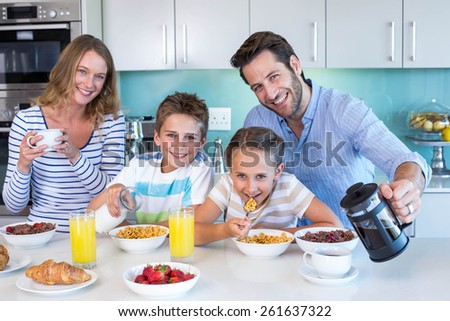 Happy family having breakfast together at home in the kitchen