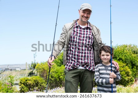Father and son looking at camera in the countryside