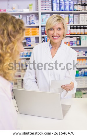 Pharmacist using the computer at pharmacy