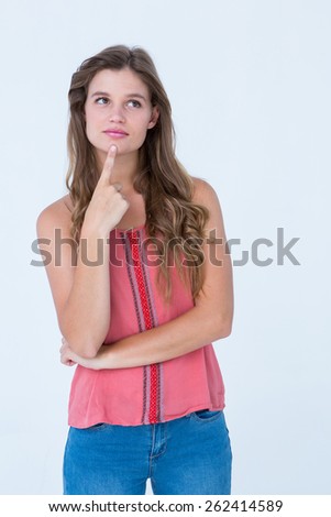 Thoughtful woman with finger on chin on white background