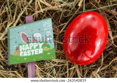 Easter egg hunt sign against red egg on straw