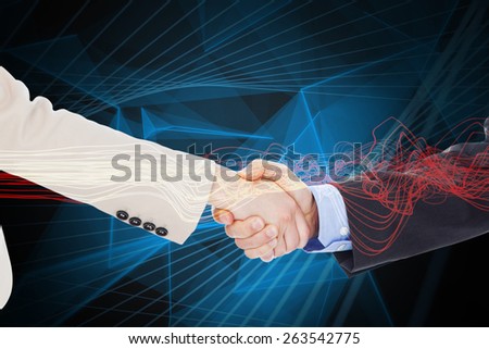 Smiling business people shaking hands while looking at the camera against blue design