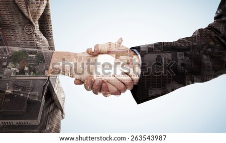 Close up of two businesspeople shaking their hands against new york