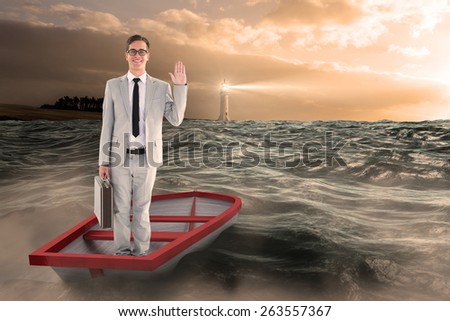Businessman waving in boat against stormy sea with lighthouse
