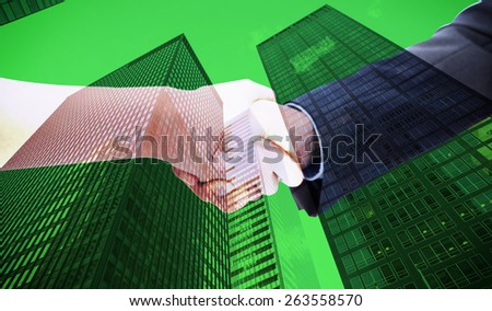 Close up of a handshake against skyscraper