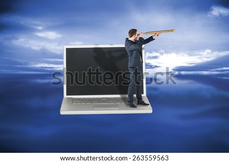 Businessman looking through telescope against blue sky with blue clouds