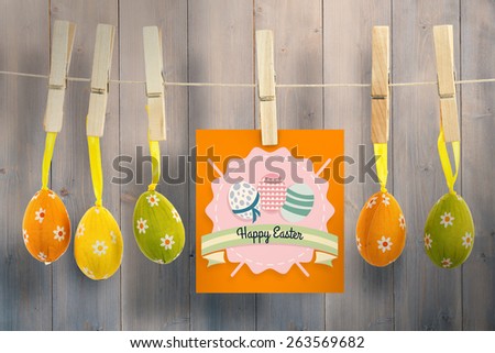 happy easter graphic against pale grey wooden planks
