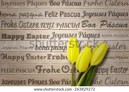 Happy easter in different languages against wooden surface with planks