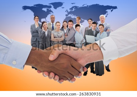 Close-up shot of a handshake in office against black world map
