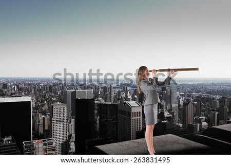 Businesswoman looking through a telescope against high angle view of city skyline