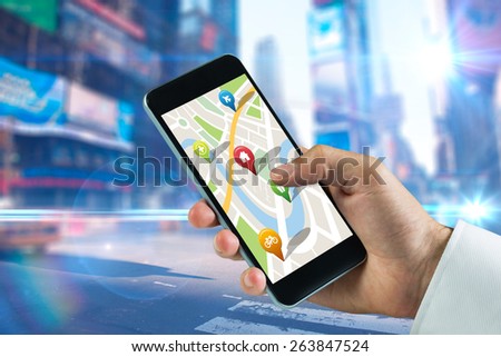 Man using map app on phone against blurred new york street