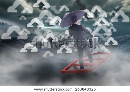 Businessman in boat with umbrella against stormy sea with lighthouse