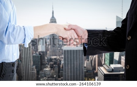 Close up of a business people closing a deal against new york
