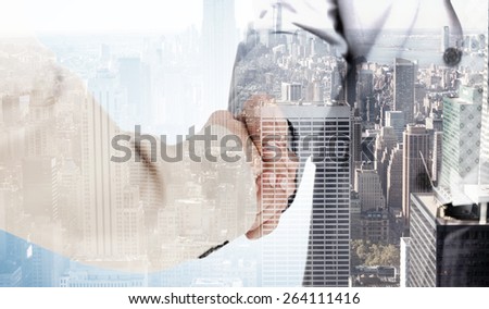 People in suit shaking hands against city skyline