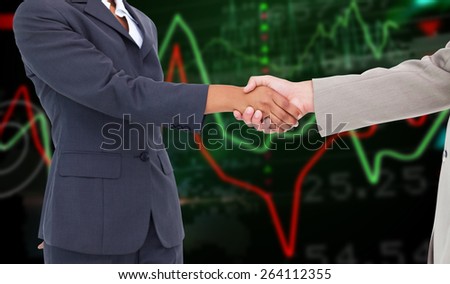 Side view of hands shaking against stocks and shares on black background