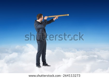 Businessman looking through telescope against blue sky over clouds