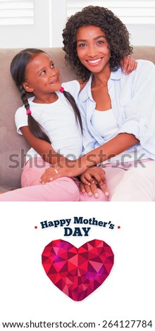 happy mothers day against pretty mother sitting on the couch with her daughter smiling at camera