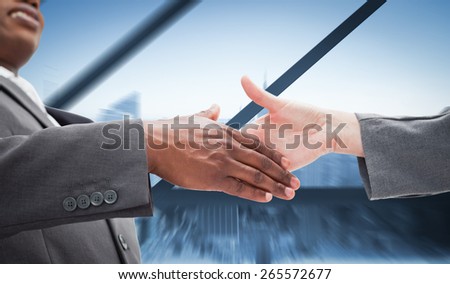 Businessman going shaking a hand against room with large window looking on city