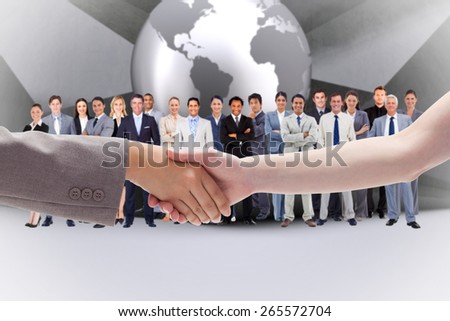 Handshake between two women against planet on grey abstract background