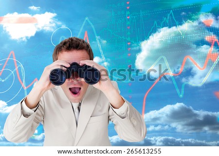 Positive businessman using binoculars against stocks and shares on black background