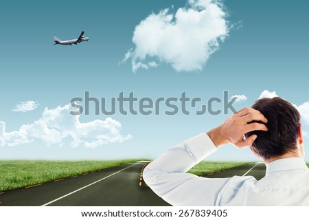 Businessman scratching his head against road leading out to the horizon