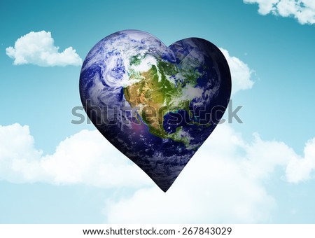 Heart shaped earth against blue sky