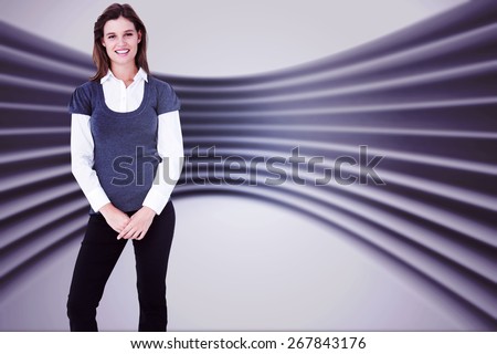 Happy woman smiling at camera against abstract room