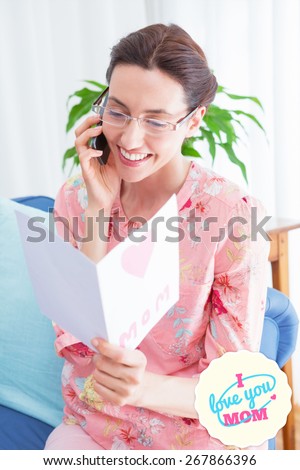 mothers day greeting against mother reading a lovely card on phone call