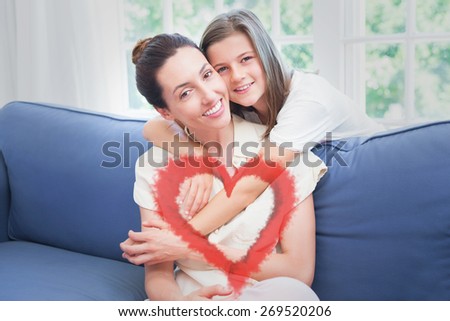 Red smoke heart against mother and daughter smiling at camera