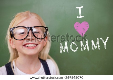 Cute pupil smiling against green chalkboard