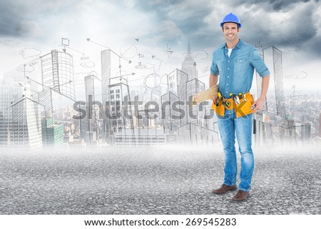 Happy carpenter with wooden planks against black road