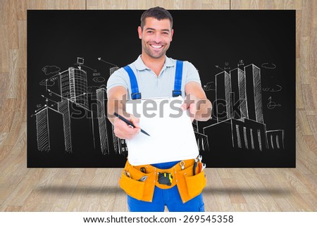 Smiling handyman giving clipboard for signature against composite image of black card