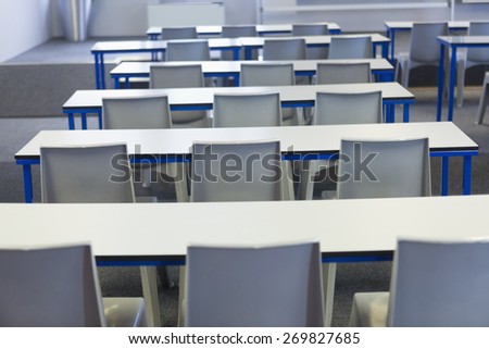Empty classroom in the college with desks and chairs